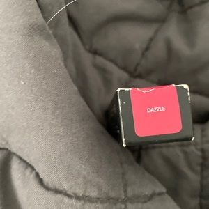 is a neutral-toned, medium-dark red with a sparkle finish permanent lipstick